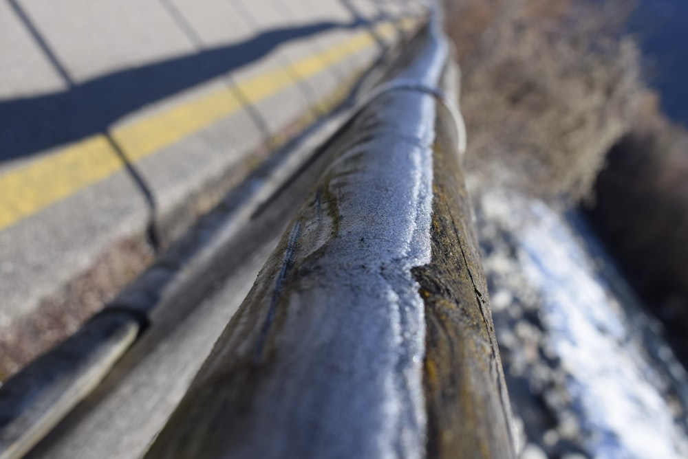 a close up of a metal rail on a sidewalk