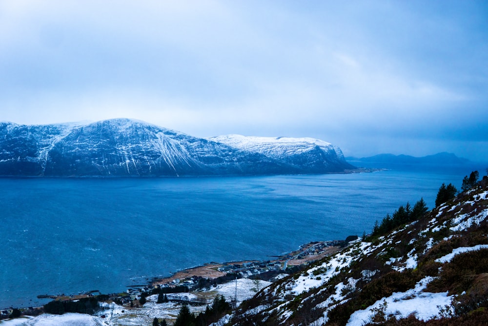 a view of a large body of water with mountains in the background