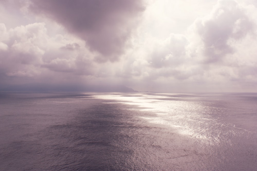 a large body of water under a cloudy sky