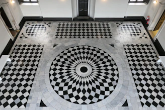 a black and white checkered floor with a circular design