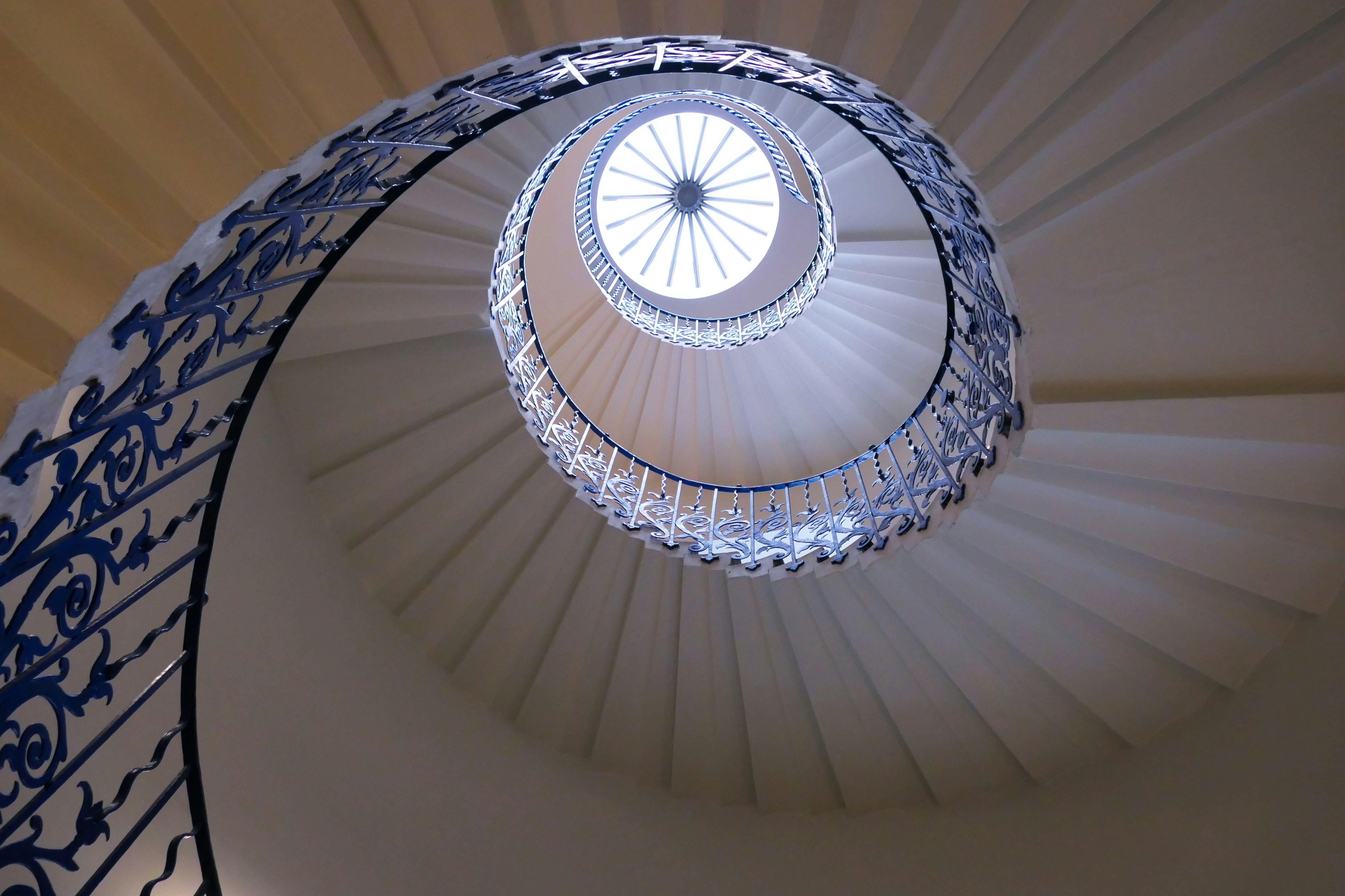a spiral staircase in a building with a skylight