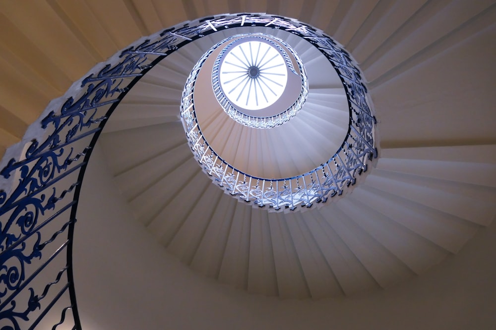 a spiral staircase in a building with a skylight