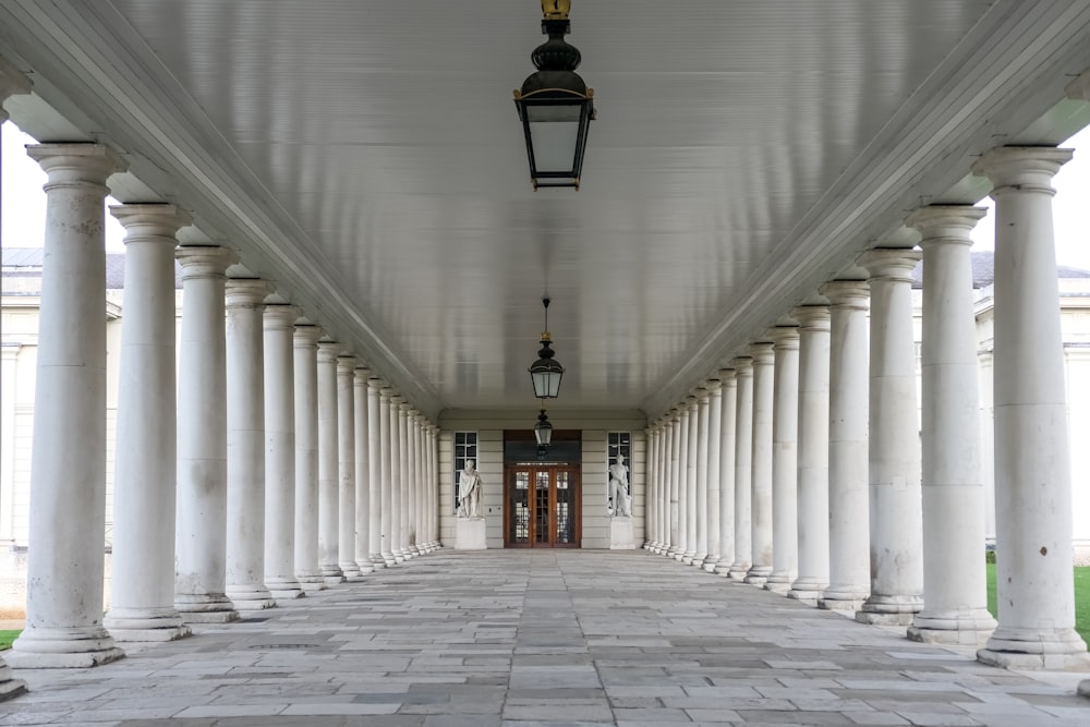a long hallway with columns and a lantern