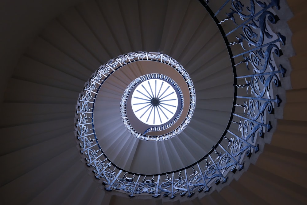 a spiral staircase in a building with a skylight