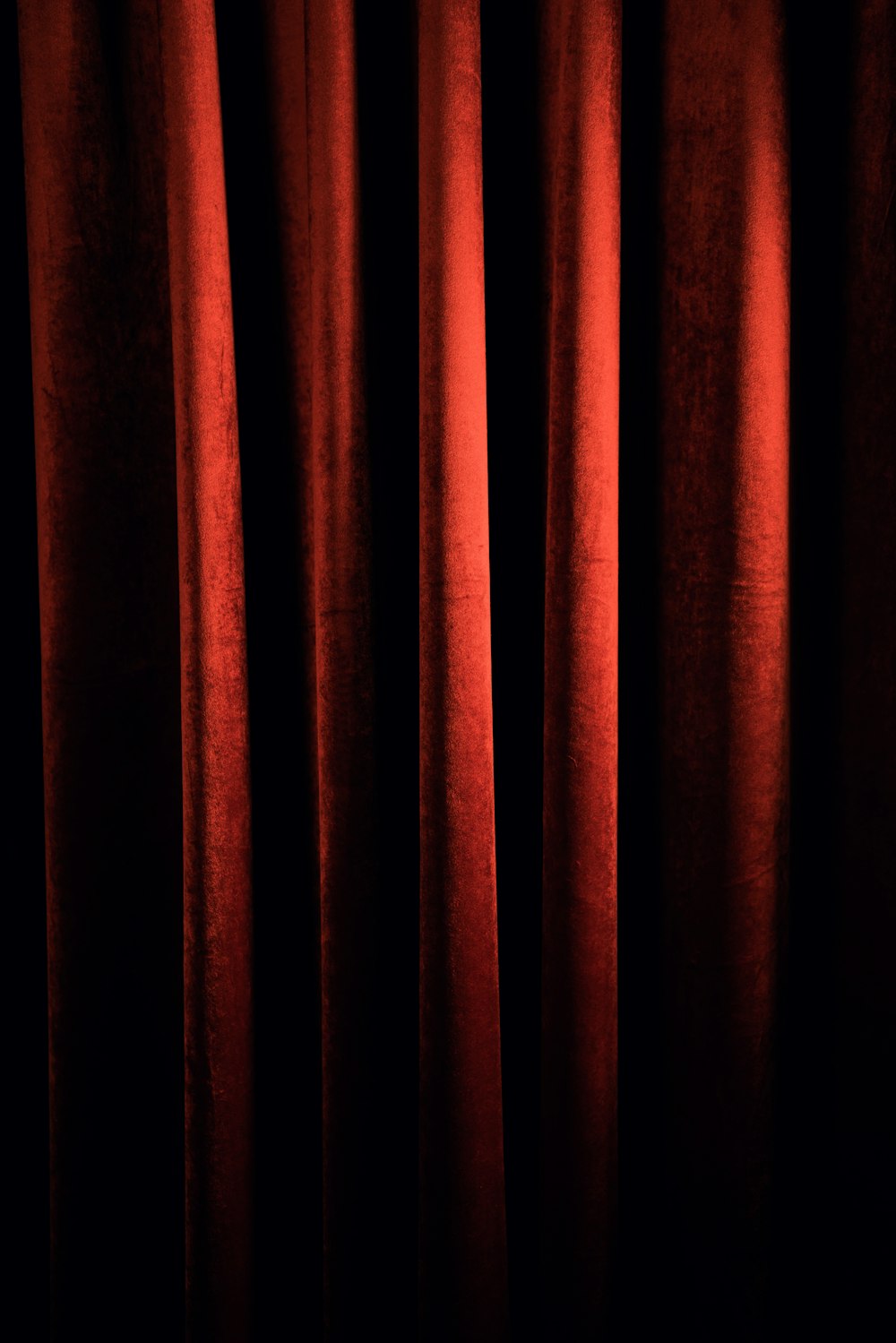 a red curtain with a black background