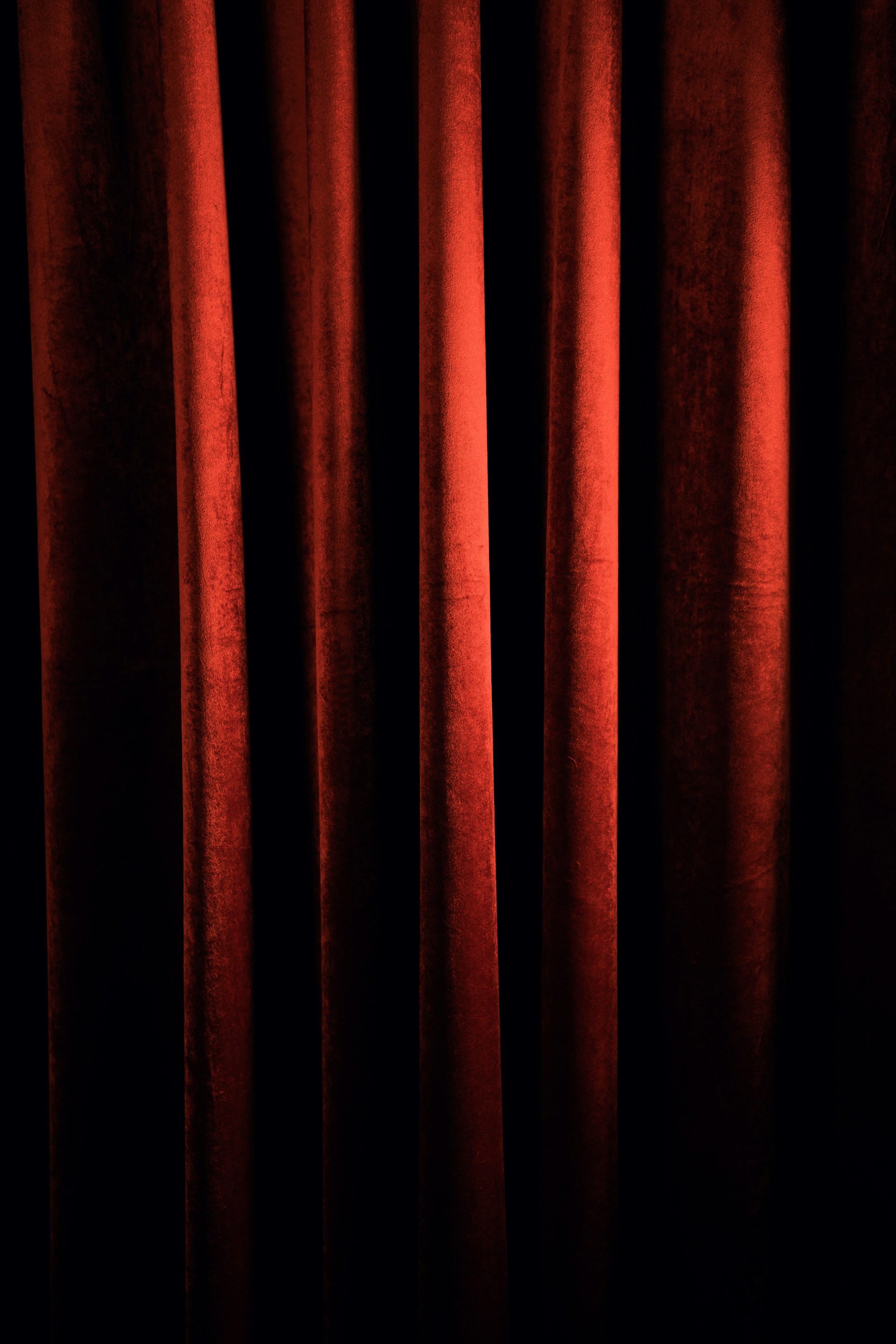 a red curtain with a black background