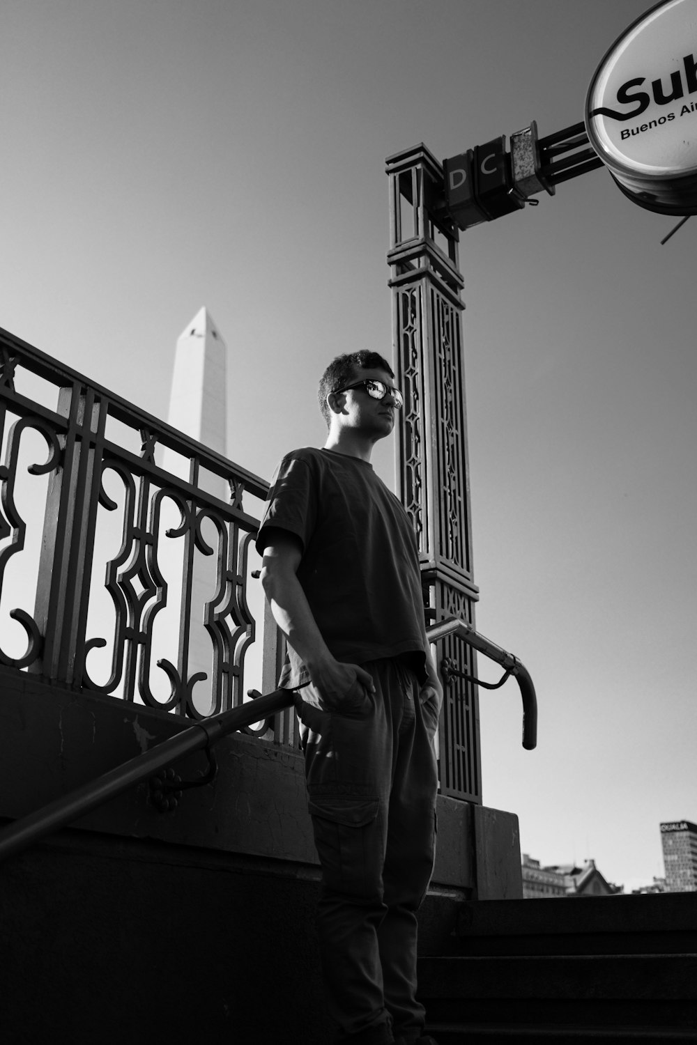 a man standing on a stair case next to a sign