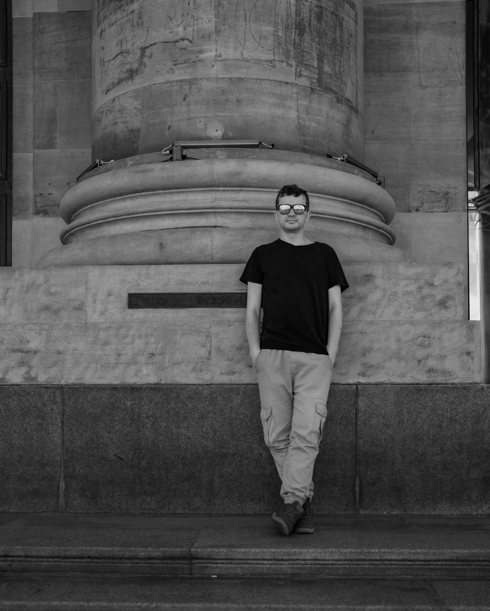 a man is standing in front of a monument