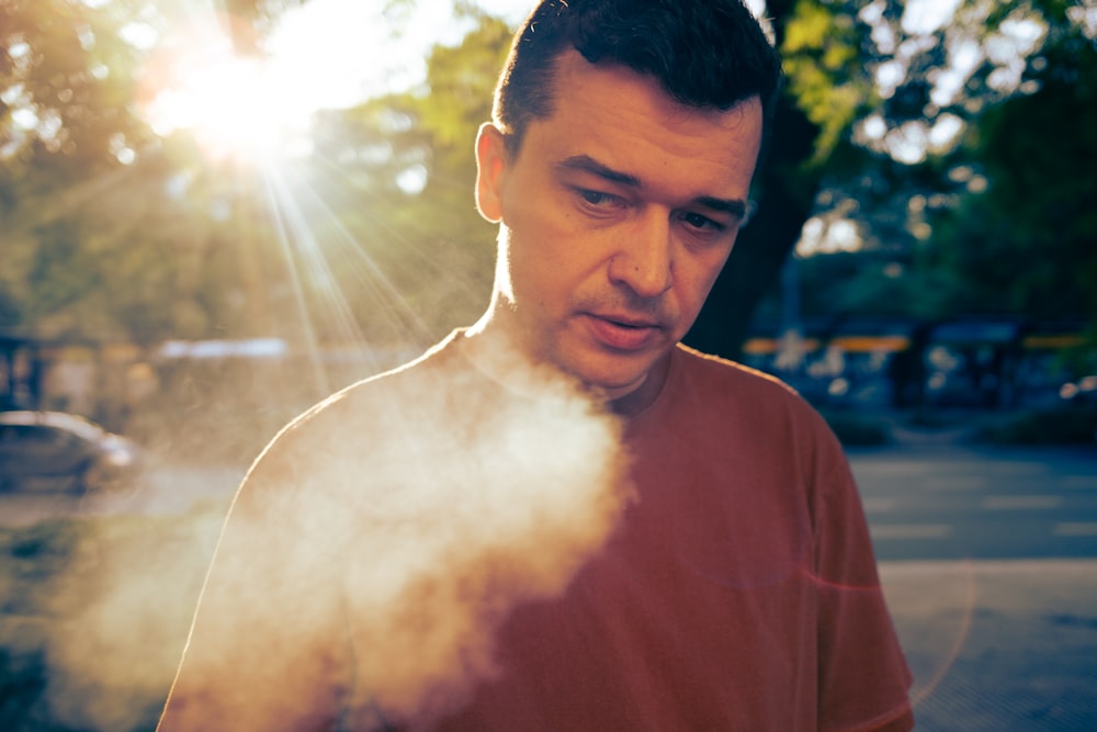 a man standing in front of a street with a lot of smoke coming out of