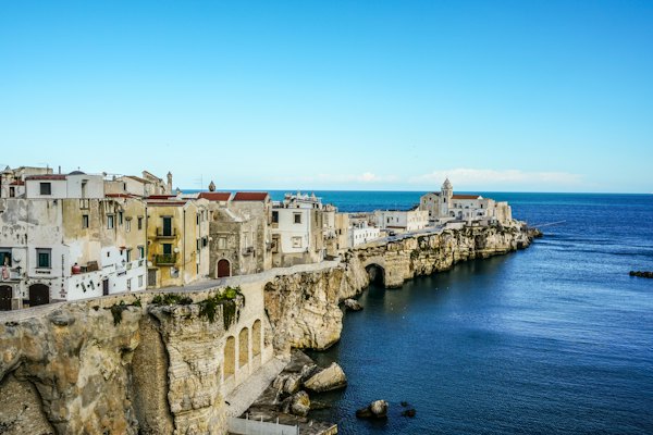 A city on the edge of a cliff next to the ocean — Puglia, Italy