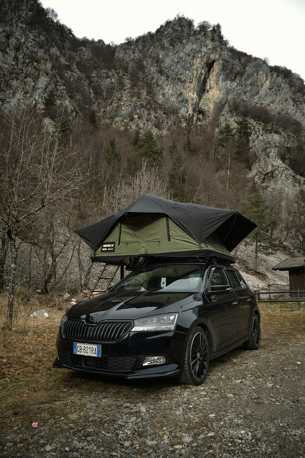 a black car with a tent on top of it