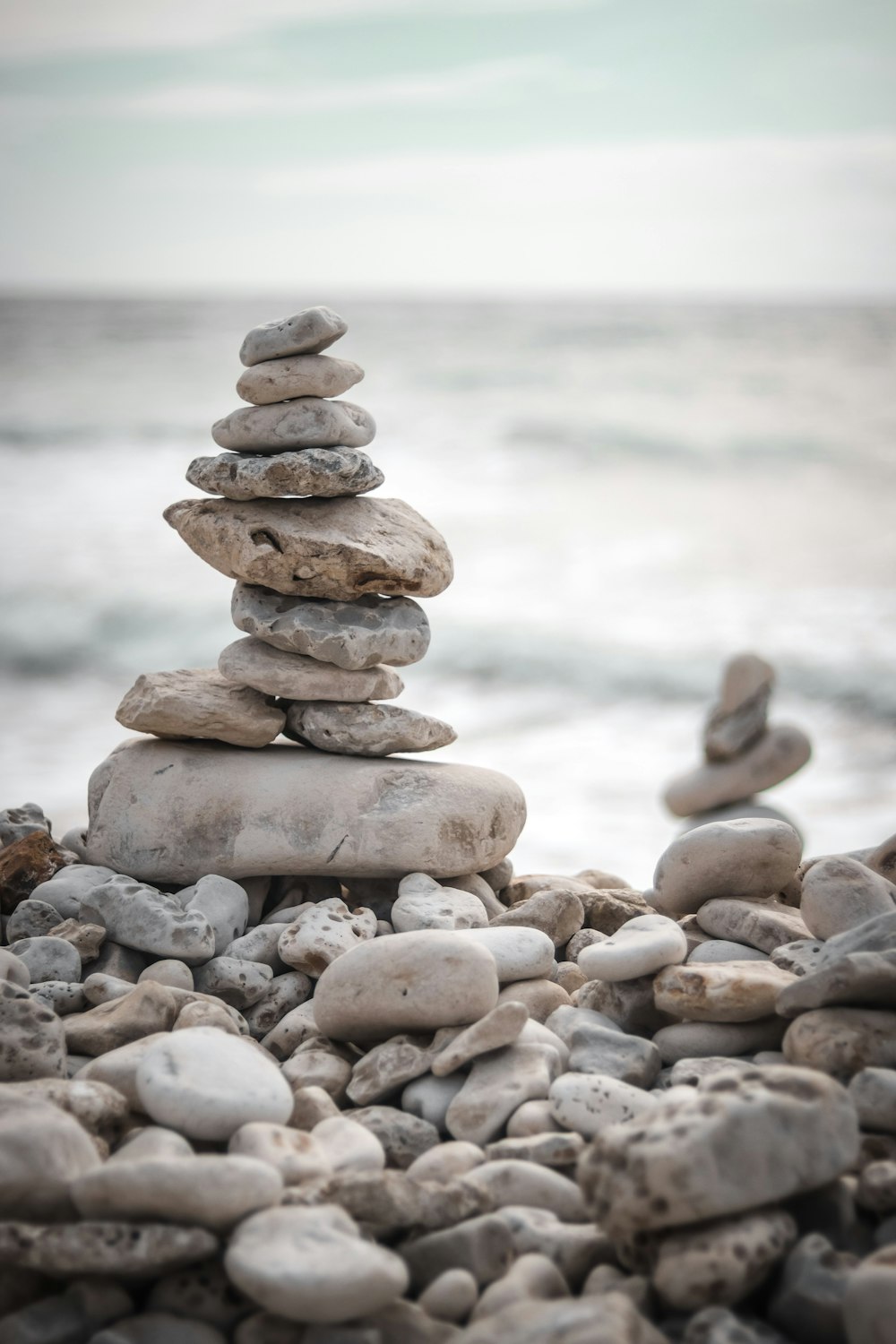 a pile of rocks sitting on top of a beach