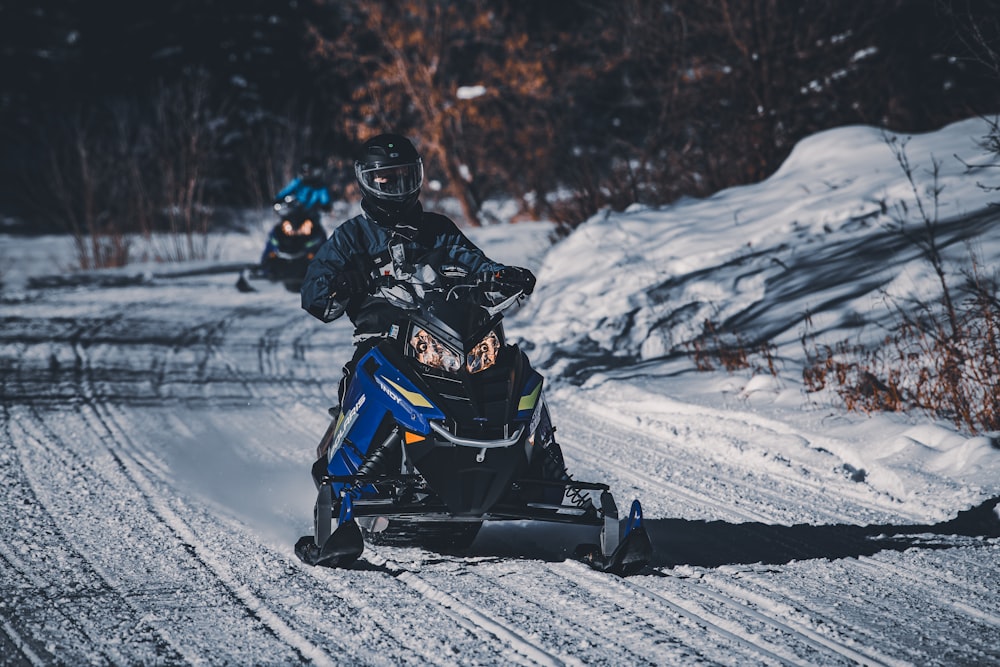 two people riding on a snowmobile in the snow