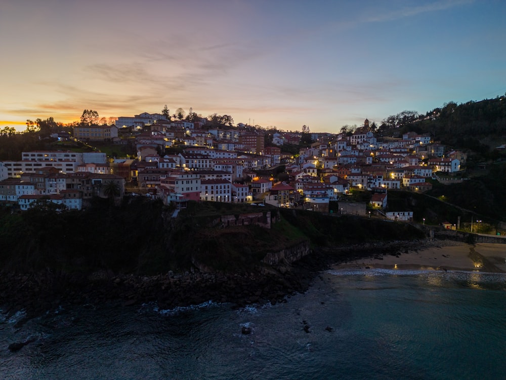 a view of a city at night from the ocean