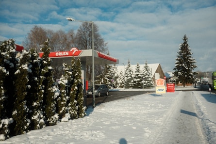 a gas station in the middle of a snowy street