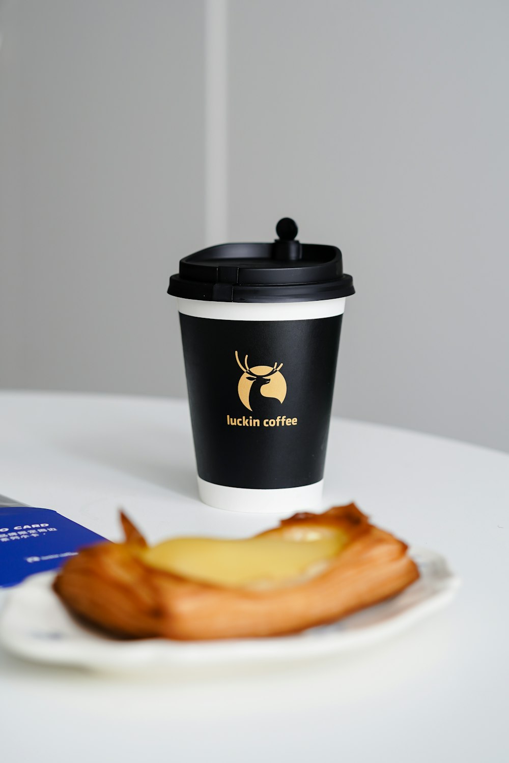 a cup of coffee sitting on top of a white table