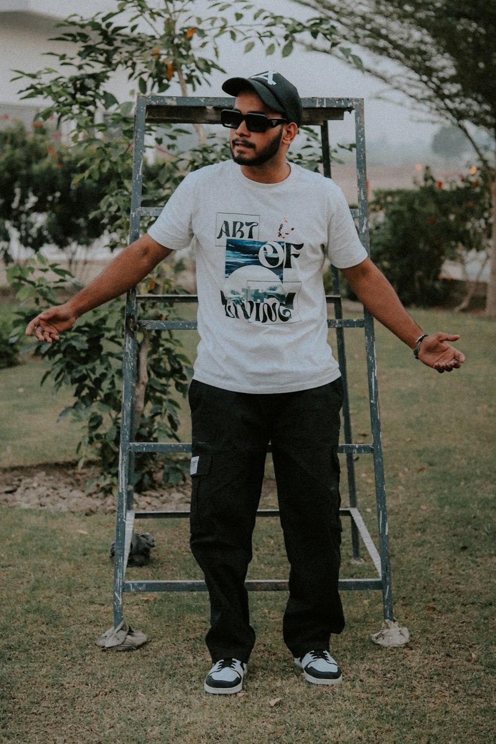 a man standing in front of a metal ladder