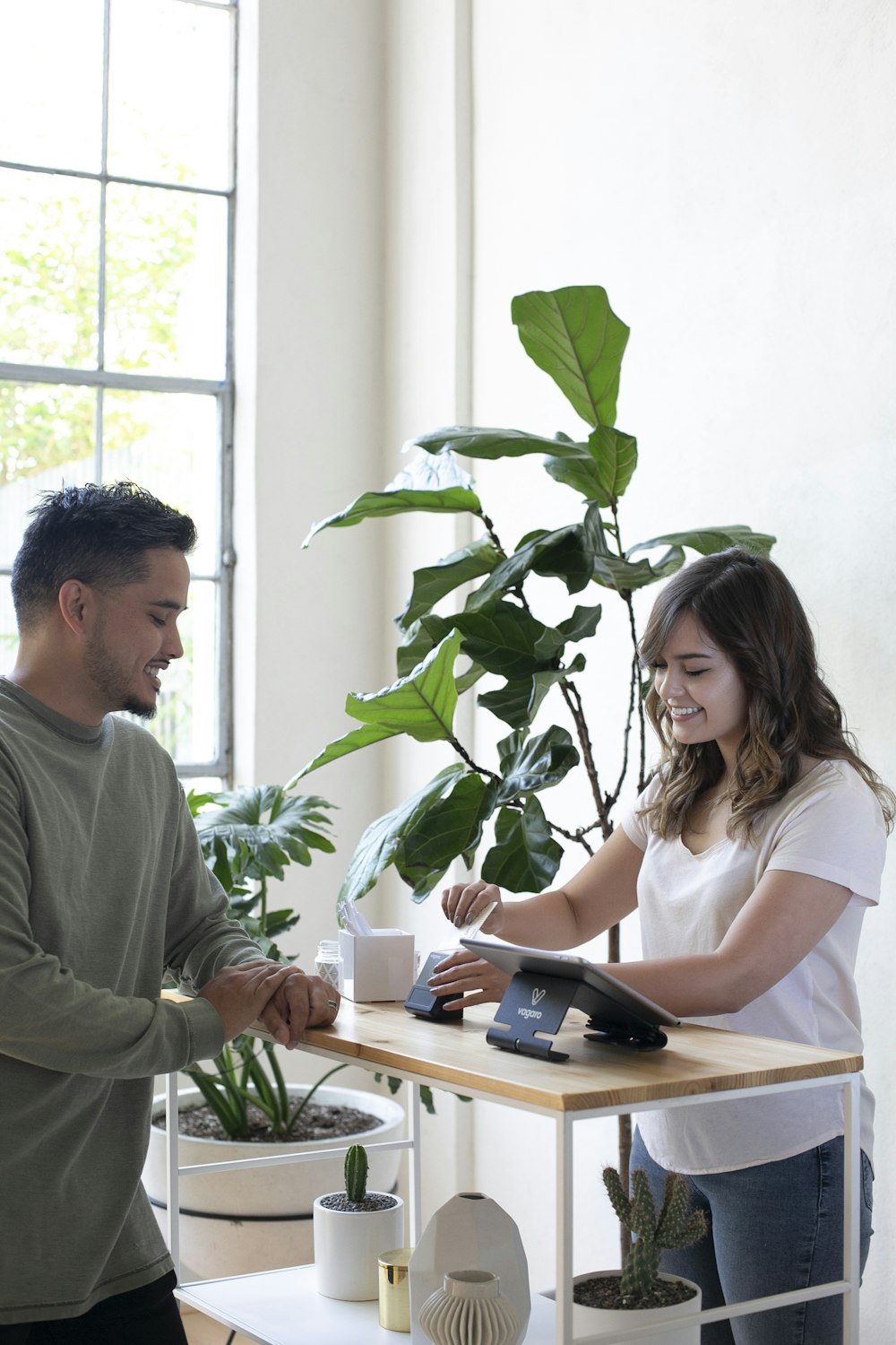 a man and a woman shaking hands over a desk