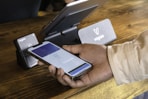 a person holding a cell phone in their hand