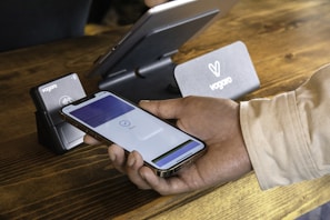 a person holding a cell phone in their hand