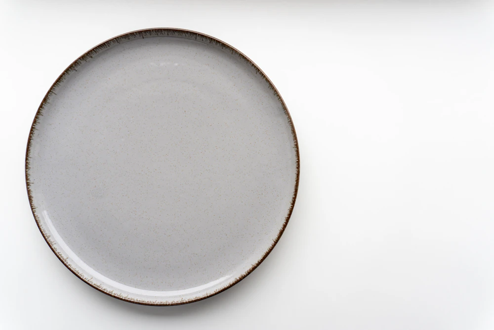Grey stoneware dinner plate with dark rim