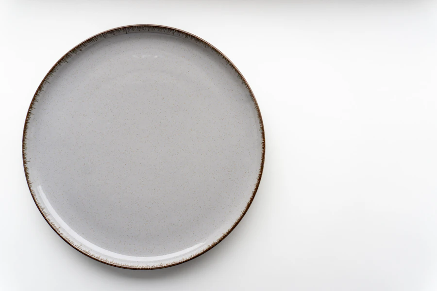Elegant white plate with a brown rim, plated fine dining course