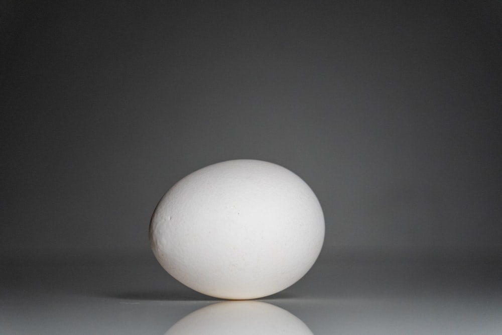 a white egg sitting on top of a table