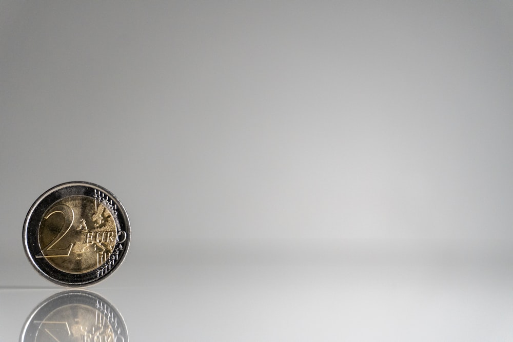 a close up of a coin on a reflective surface