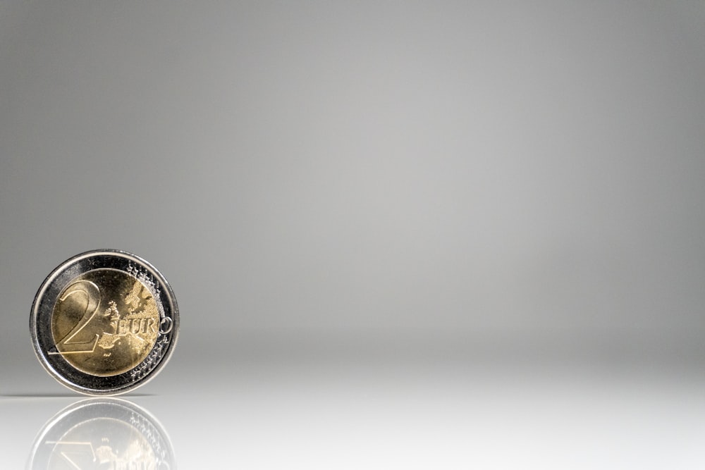 a close up of a coin on a white surface