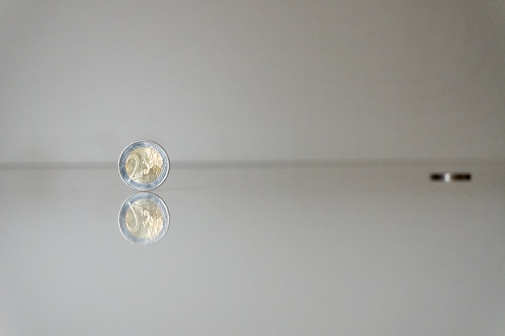 a white wall with a reflection of a light on it