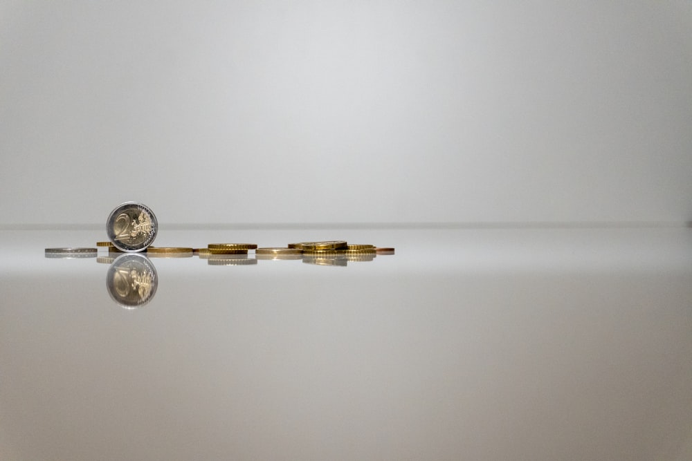 a coin sitting on top of a reflective surface