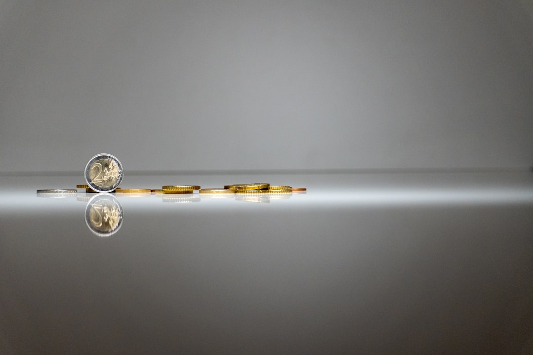 a silver and gold object with a reflection in the water,