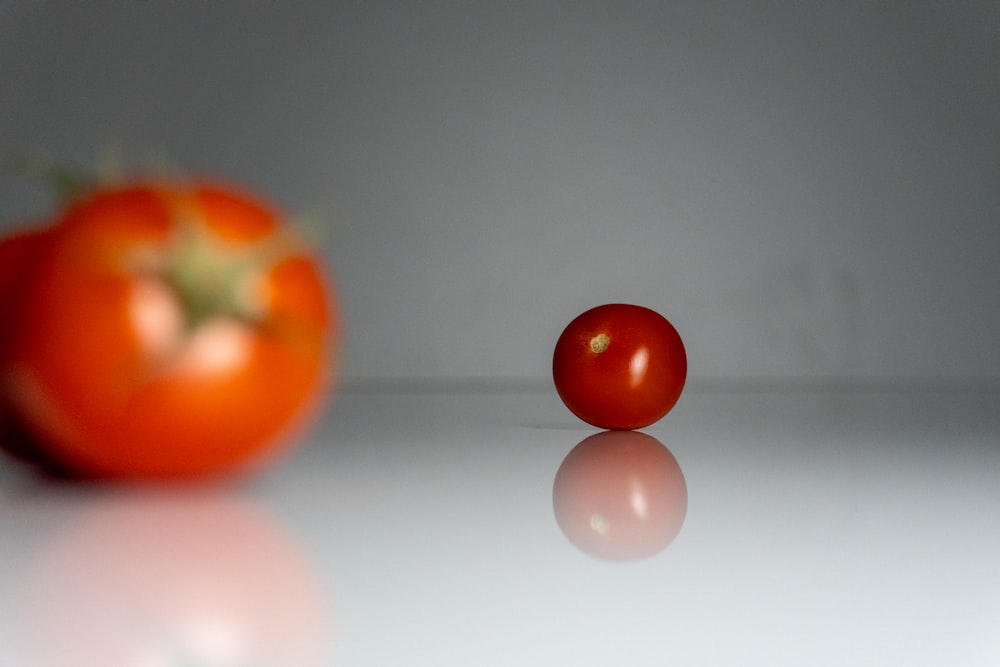 a close up of two tomatoes on a table