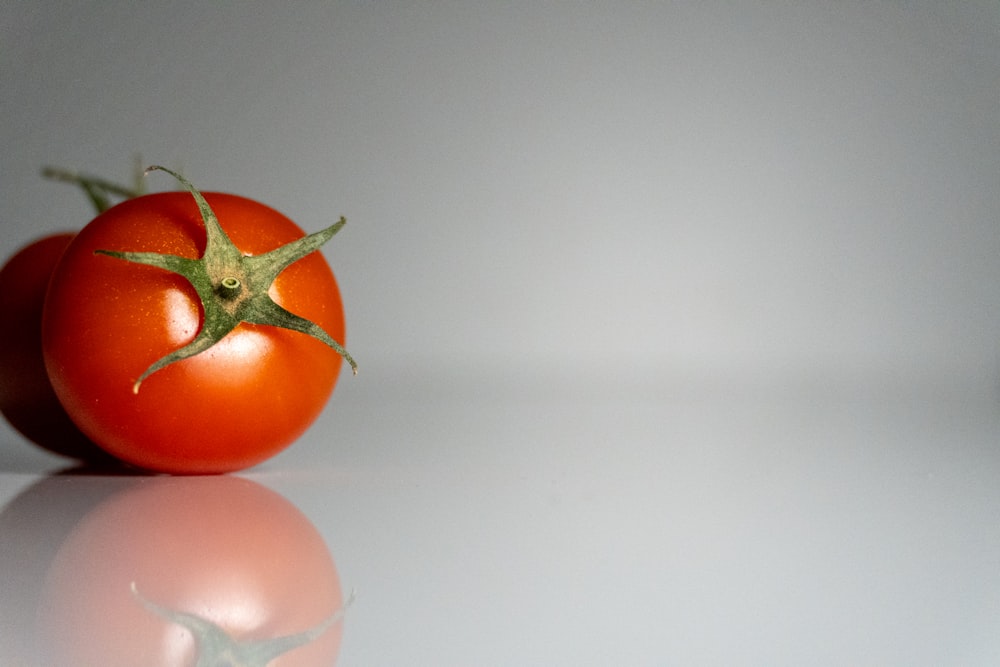 a close up of a tomato on a white surface