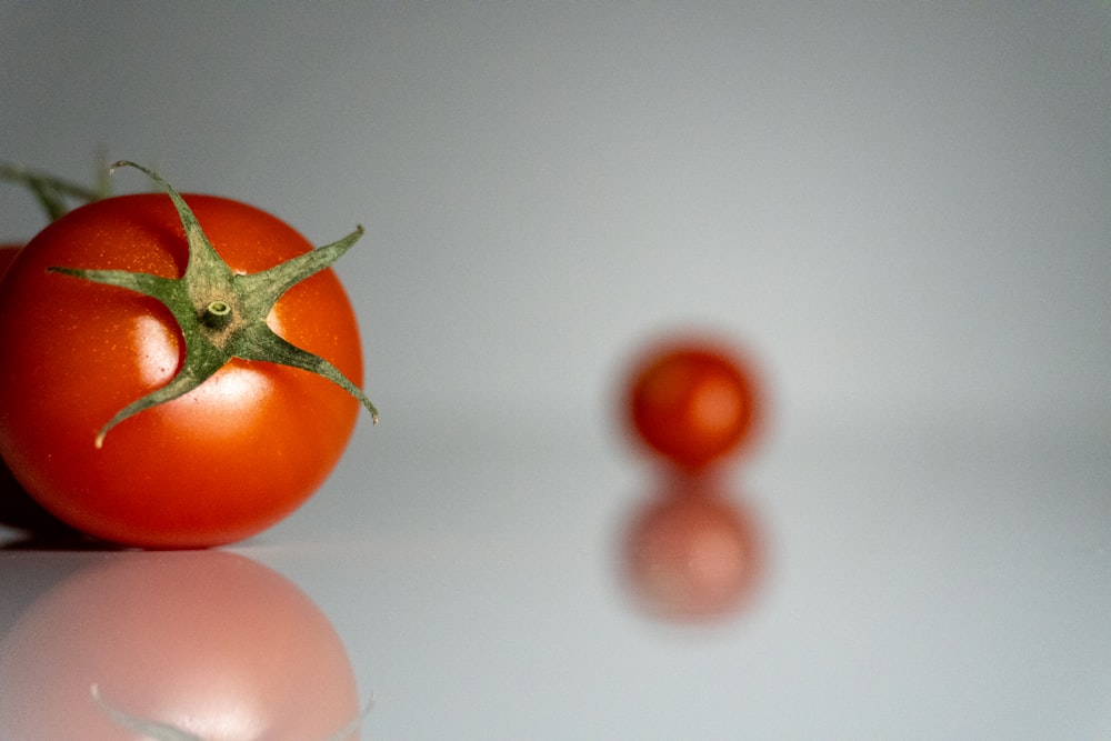 a close up of two tomatoes on a table