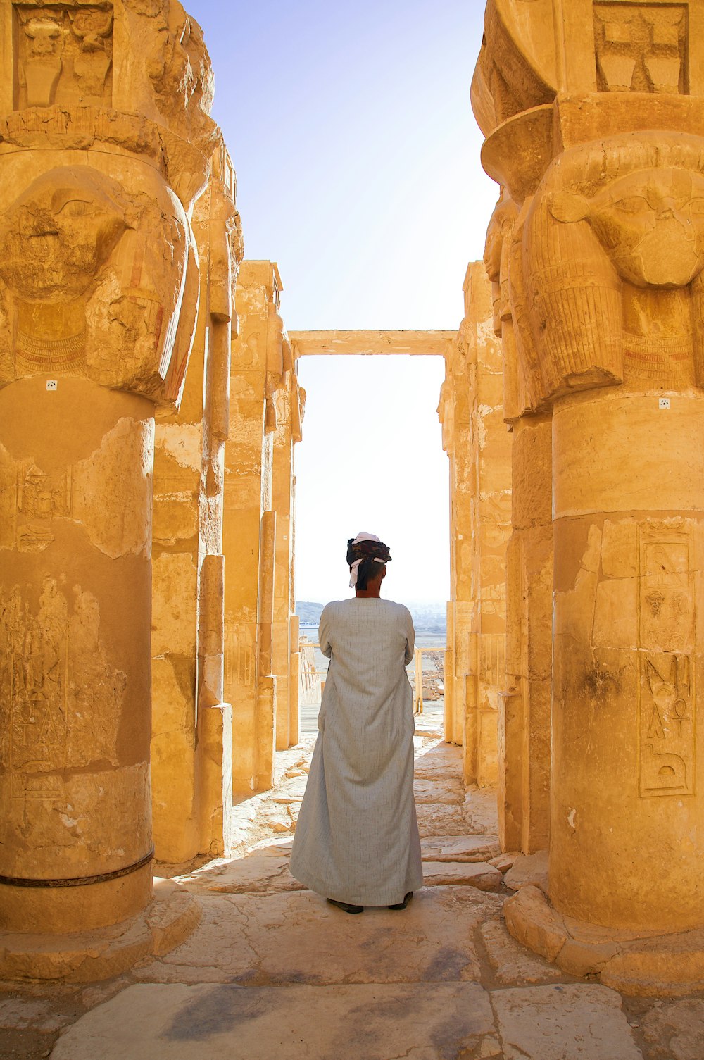 a woman in a white dress standing in a doorway