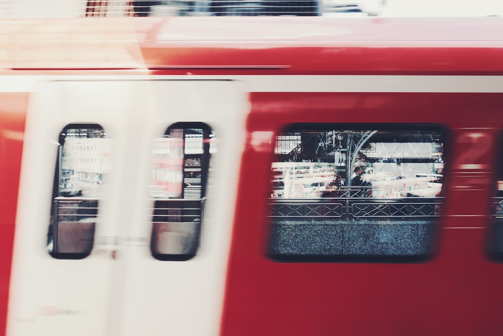 a red and white train traveling down train tracks