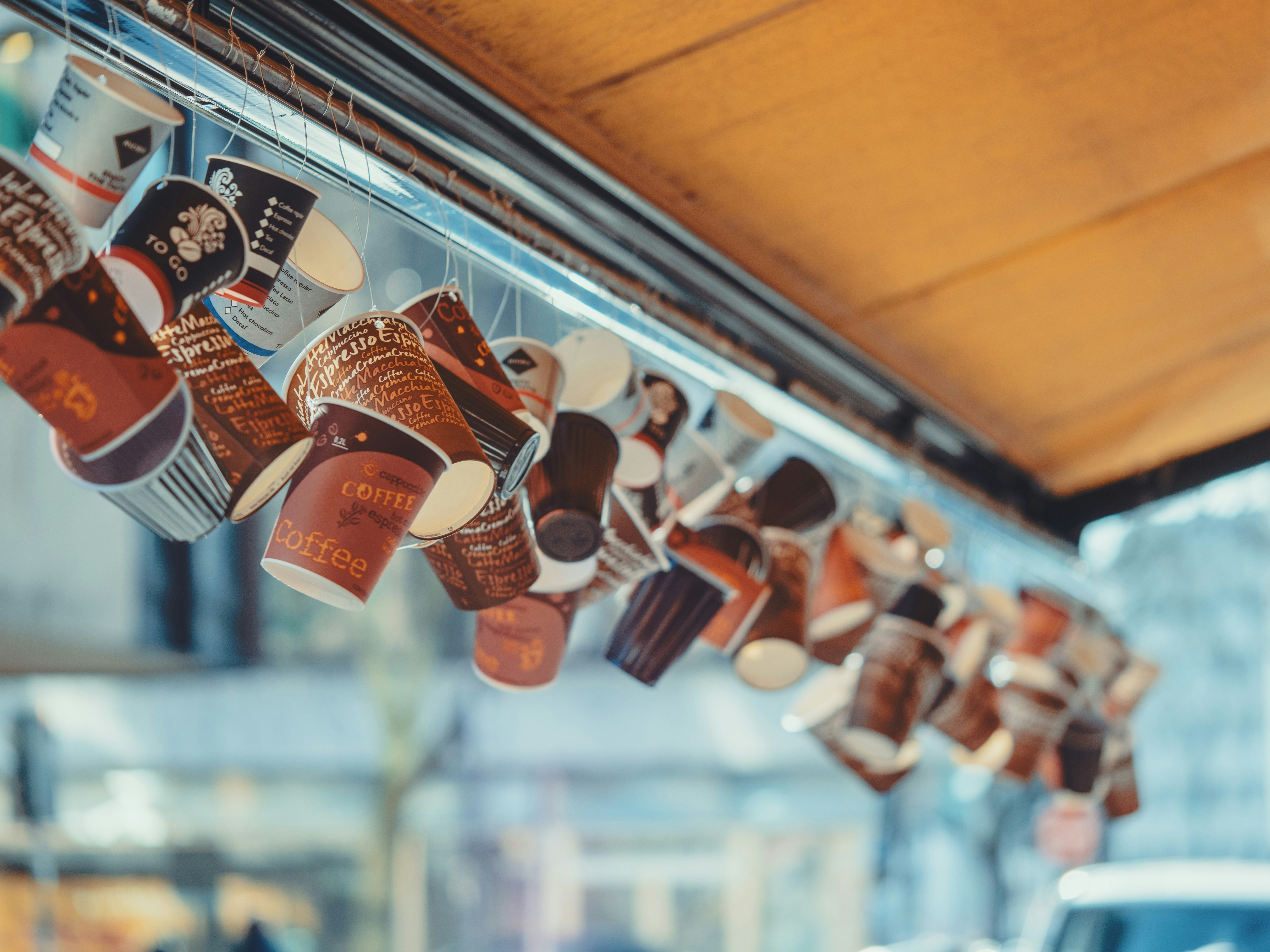 Cups of coffee hanging from a rack