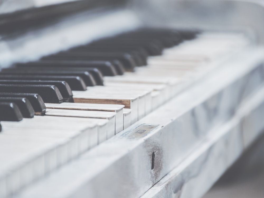 a close up of a piano keyboard with a blurry background