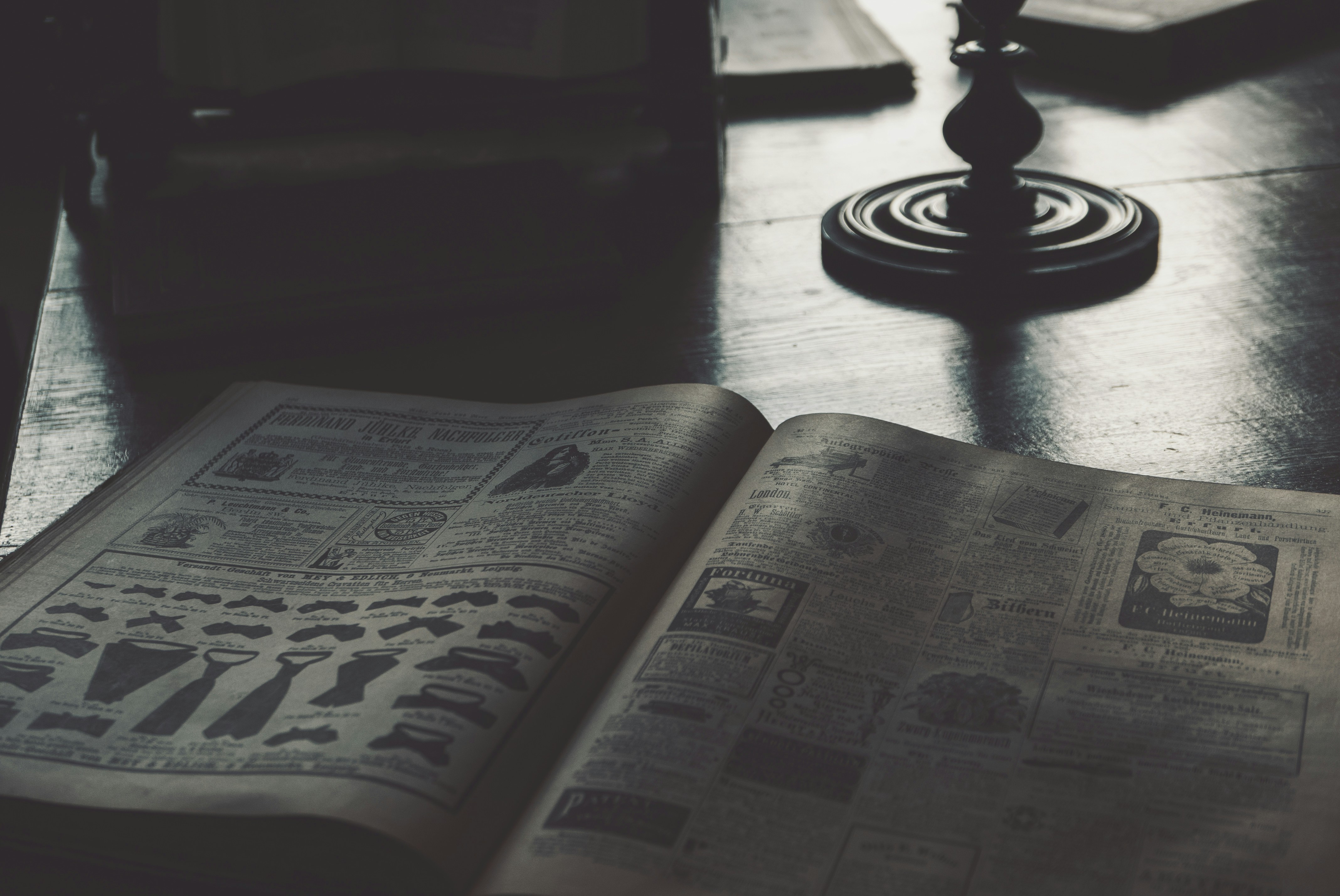 an open book sitting on top of a wooden table