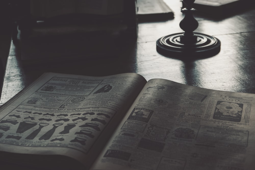 an open book sitting on top of a wooden table