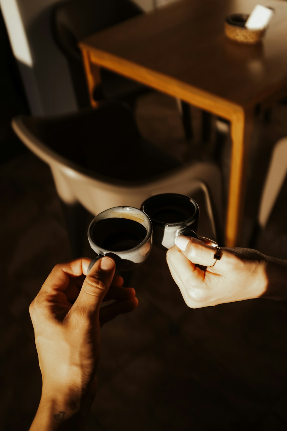 a person holding a cup of coffee in their hands