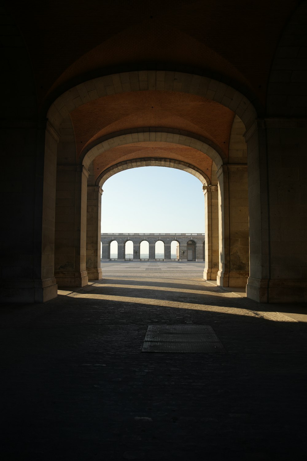 a view of a walkway with arches in the middle of it