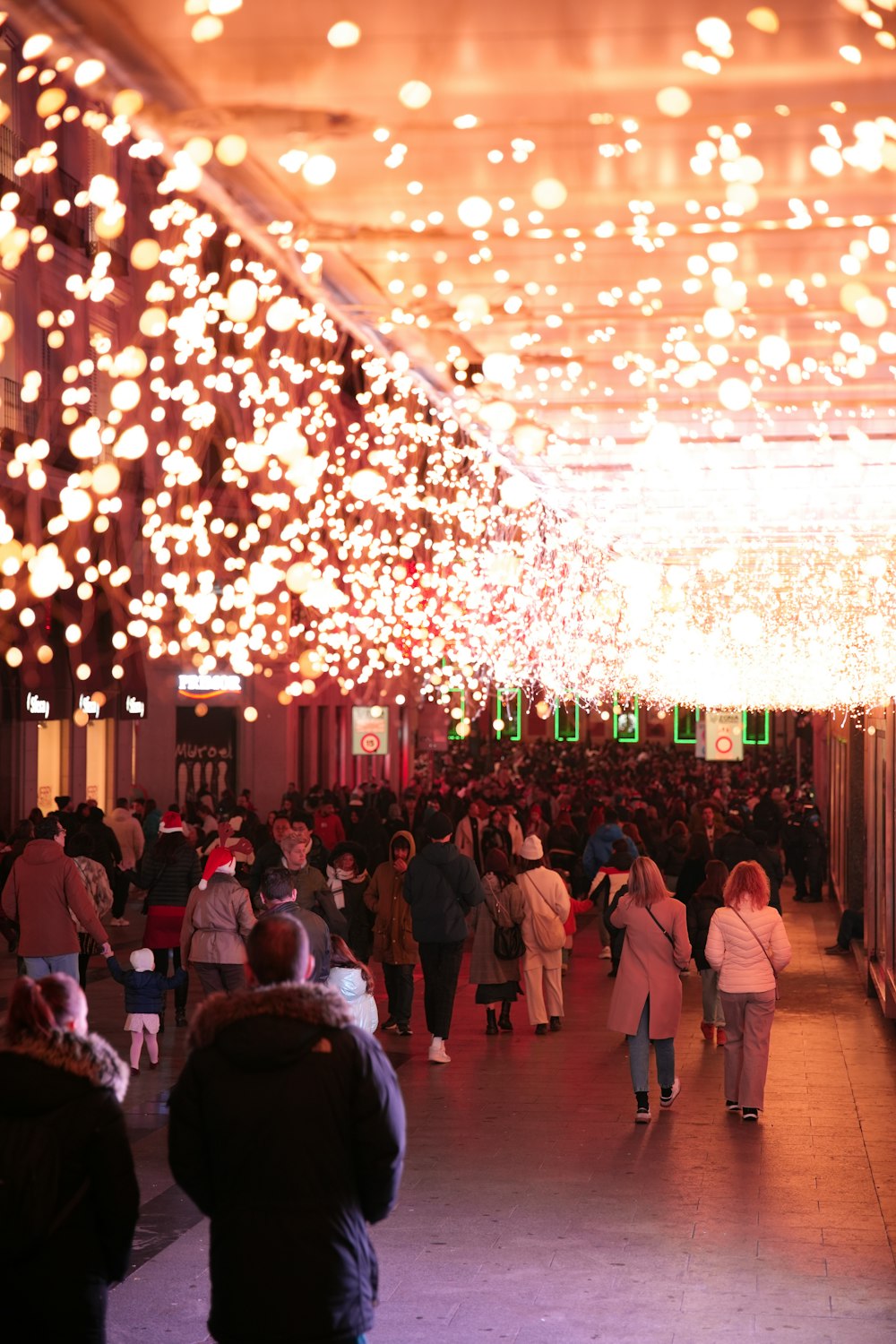 a large group of people walking down a hallway