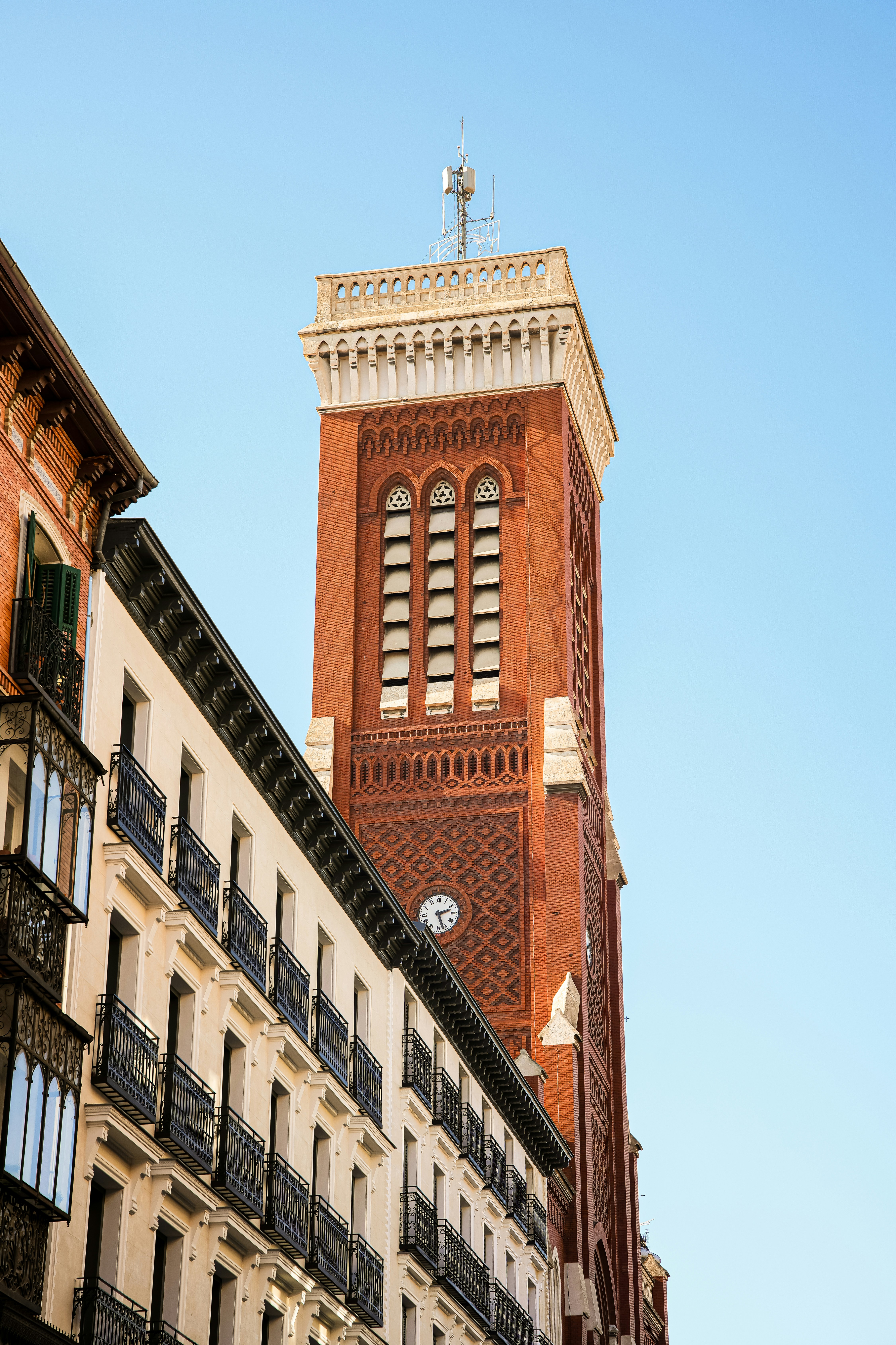 a tall brick clock tower towering over a city