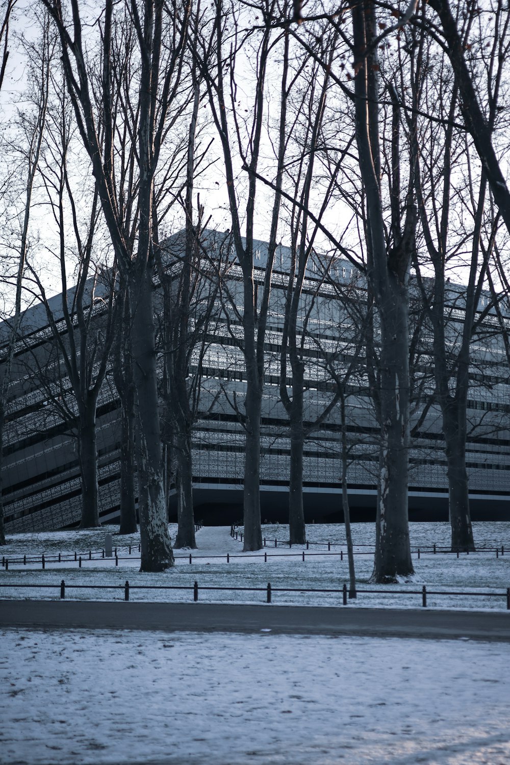 a building surrounded by trees in the snow