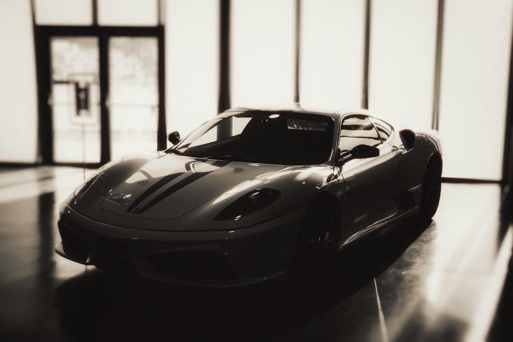 a black and white photo of a sports car