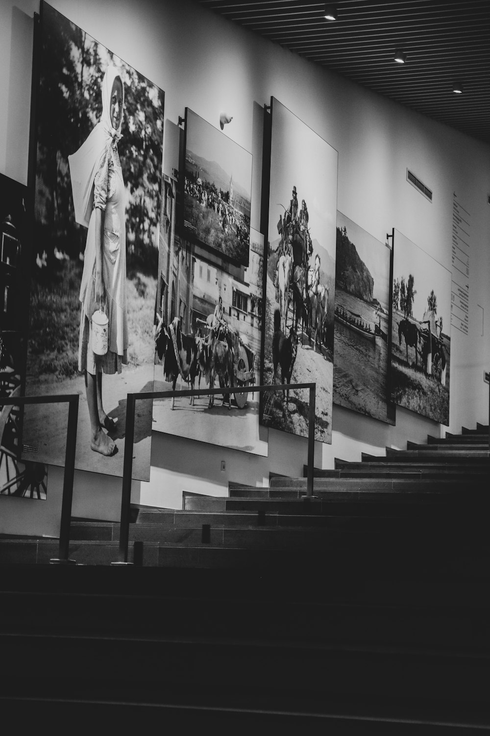 a black and white photo of a wall with pictures on it