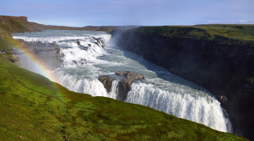 a waterfall with a rainbow in the middle of it