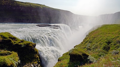 a large waterfall with water cascading down the side of it